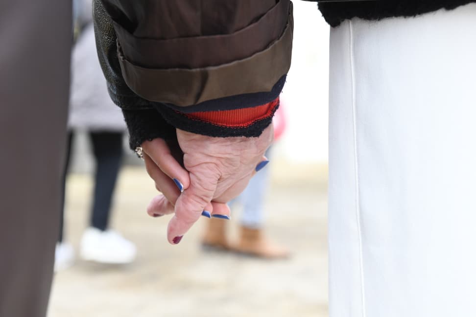 Demenz-Patientin hält Hand ihrer Betreuerin.